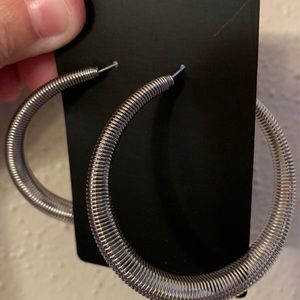 *NWOT* Beautiful Silver Earrings. New, It stretches and measurements can be seen